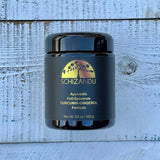 A black jar of Schizandu Ayurvedic Full-Spectrum Curcumin-Gingerol Formula, with a label that includes the product name and weight, placed on a wooden surface.