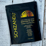 A sealed package of SCHIZANDU 100% Pure Food Grade Bentonite Clay, Indian Healing Clay in a black color bag with product details.