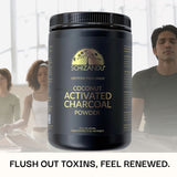 Black container of Schizandu coconut activated charcoal powder with people in the background.
