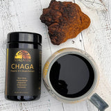Chaga organic 8 by 1 dual extract with its prepared drink next to it, Schizandu