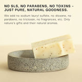Bar of soap on a stone dish with text about product ingredients on a beige background