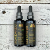 Two bottles of Schizandu Omega-3 DHA on a wooden surface
