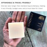 Hand holding a shampoo bar with Schizandu packaging on a concrete surface