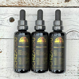 Three bottles of Schizandu Omega-3 DHA on a wooden surface