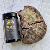 Schizandu Reishi supplement jar next to a piece of reishi mushroom on a textured surface