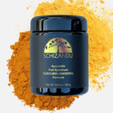 Blue jar of Schizandu Ayurvedic Full-Spectrum Curcumin-Gingerol Formula on a yellow powder background