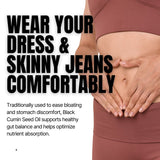 Person wearing a dress and skinny jeans with text about Black Cumin Seed Oil benefits.