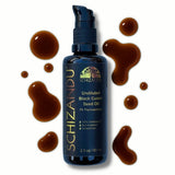 Schizandu undiluted black cumin seed oil bottle with droplets on a white background