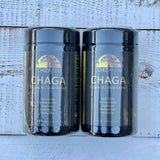 Two Schizandu Chaga organic 8:1 dual-extract containers on a wooden surface.