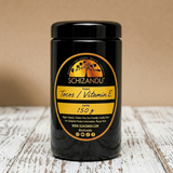 A Miron glass jar of Schizandu Tocos / Vitamin E supplement with a black lid and a yellow and black label, set on a rustic white wooden surface against a beige background.