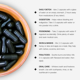 Bowl of black capsules with usage instructions and benefits on a white background
