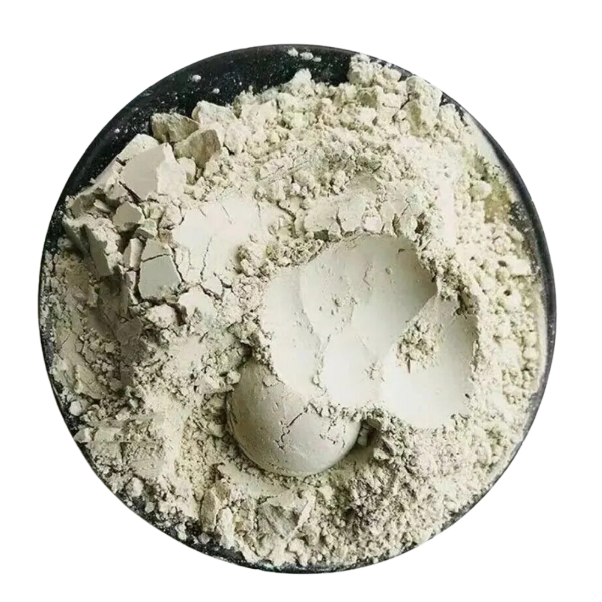 A top-down view of a light beige powder, likely clay, plaster, or pigment, piled inside a round black dish against a solid white background.
