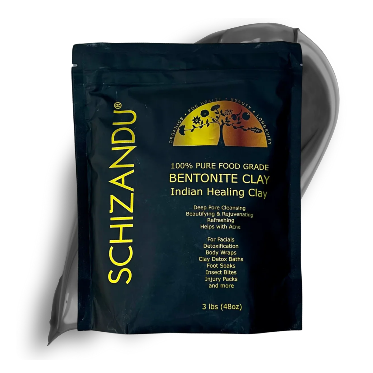 A black stand-up pouch of Schizandu Bentonite Clay Indian Healing Clay, featuring a gold and yellow logo and text, with a translucent gray sheet of clay partially visible behind it on a white background.