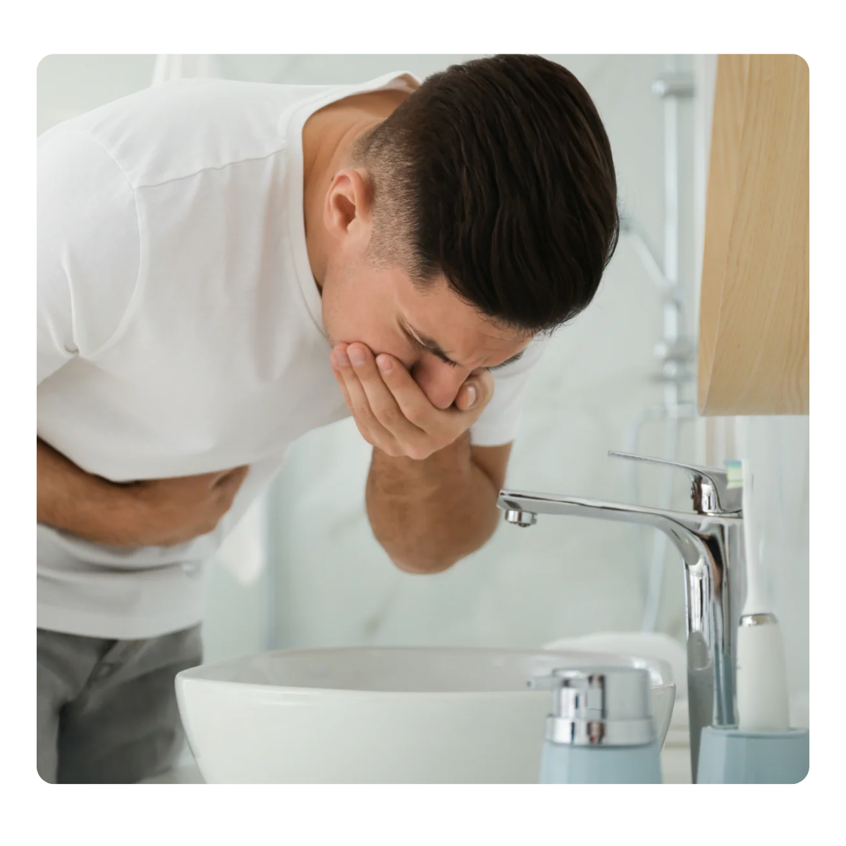 Man leaning over a sink with a concerned expression