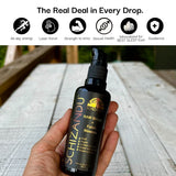 Hand holding a bottle of Schizandu Raw Shungite Fulvic Minerals on a wooden surface with product benefits listed above.