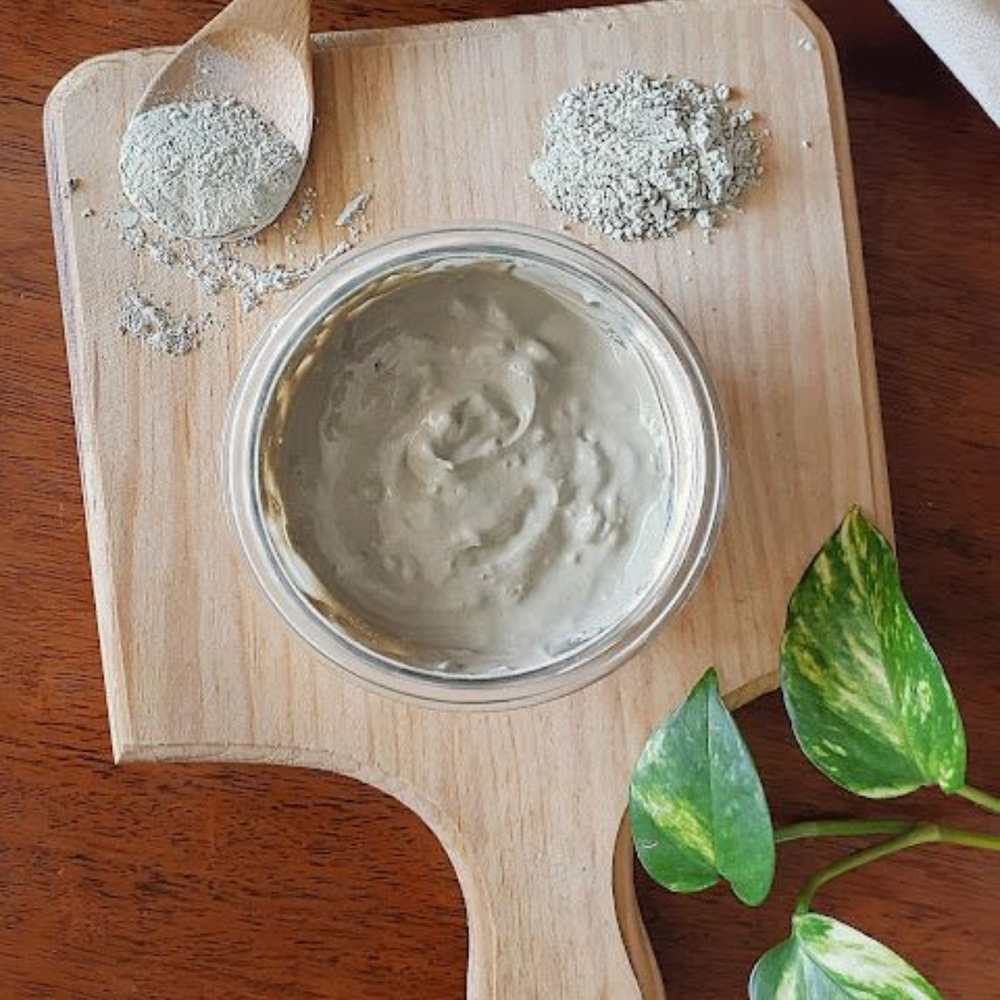 Bentonite clay powder by Schizandu Organics in a wooden board