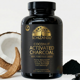 Schizandu coconut activated charcoal supplement bottle with a coconut and powder on a white background