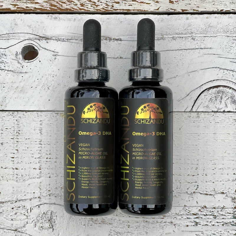 Two bottles of Schizandu Omega-3 DHA on a wooden surface