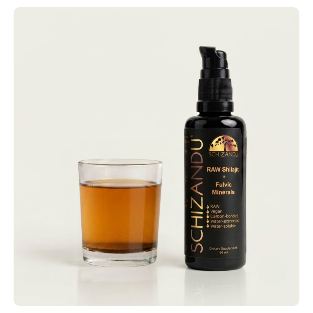A bottle of Schizandu Raw Shilajit + Fulvic Minerals next to a small glass filled with the dark amber liquid, set against a plain light background.