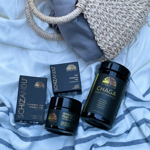 Schizandu skincare and wellness products on a textured surface
