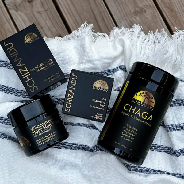Schizandu skincare products on a textured fabric background