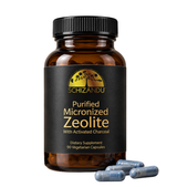 A bottle of Schizandu Purified Micronized Zeolite dietary supplement with a black label and amber bottle, shown on a white background with four blue-gray capsules in front.